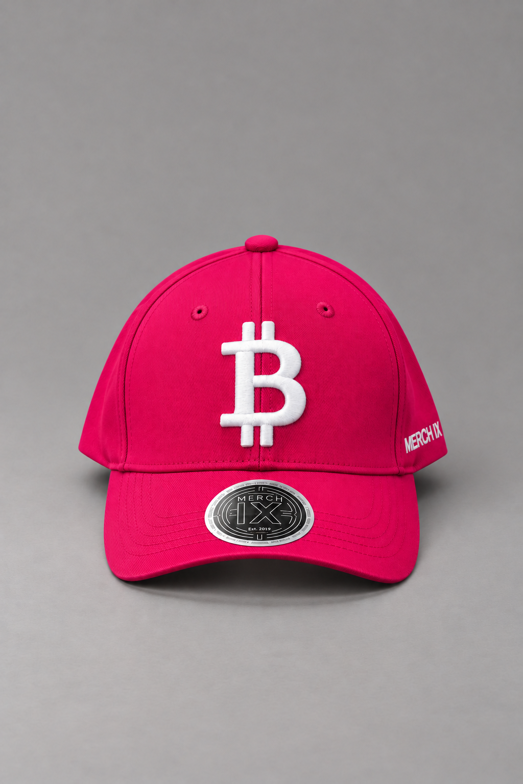 Hot pink Bitcoin baseball cap with raised white Bitcoin embroidery, white MERCH IX side branding, and metallic visor sticker.